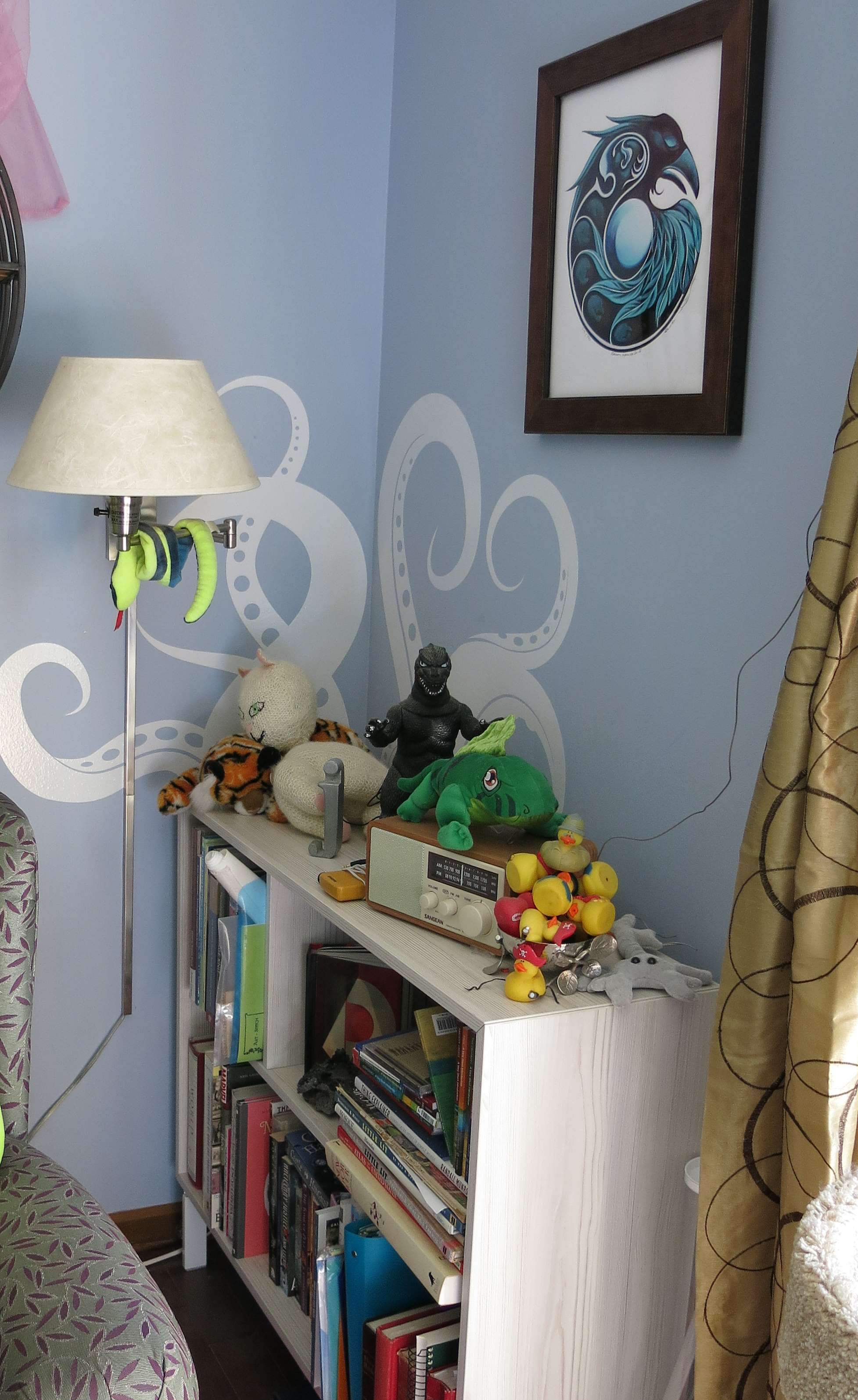 bookshelf in the corner with octupus sticker